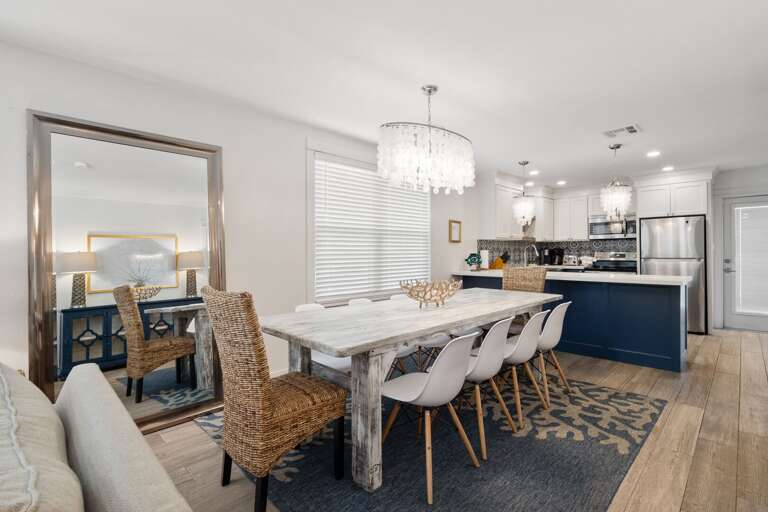 Open concept dining area and kitchen. Dining table provides ample seating for all guests to enjoy meals.