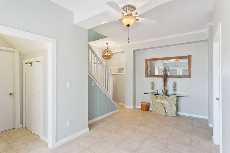 Ground floor entryway. Two guest bedrooms are located on this floor. All additional rooms are located upstairs, as well as living, room, dining area and kitchen.