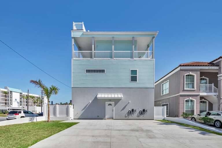 Three-story Building With Balcony And Garage Under Clear Sky