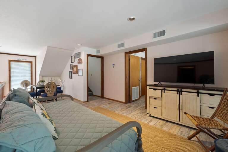 1st floor living room with twin daybed and large flat screen TV