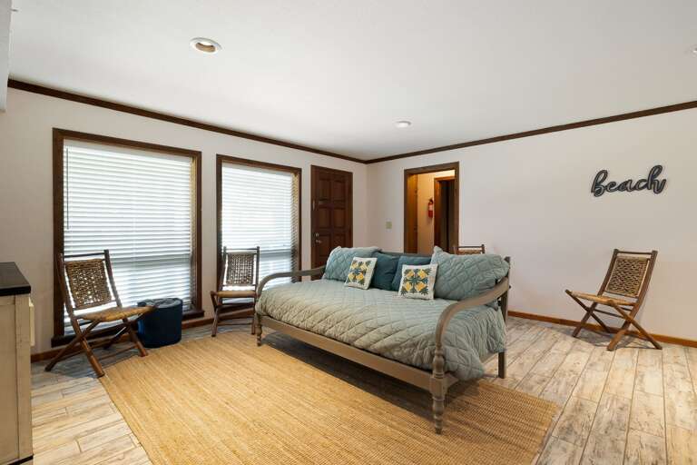 1st floor living room with twin daybed and large flat screen TV