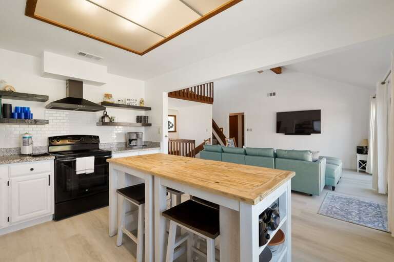 Kitchen is open concept to the living area and is fully stocked with pots, pans, dishes, etc. for your home cooked meals!