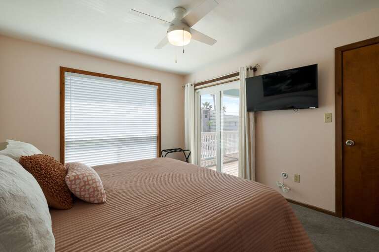Master bedroom features a flat screen TV and has private balcony access (2nd floor)