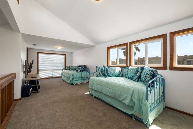 Open loft room with two twin beds and two twin trundles (3rd floor)