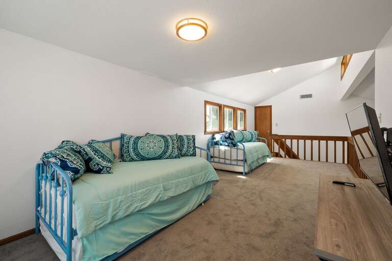 Open loft room with two twin beds and two twin trundles (sleeps 4) located on the 3rd floor