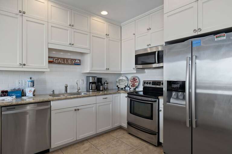Fully equipped kitchen area with pots, pans, and dishware essential for cooking your favorite meals