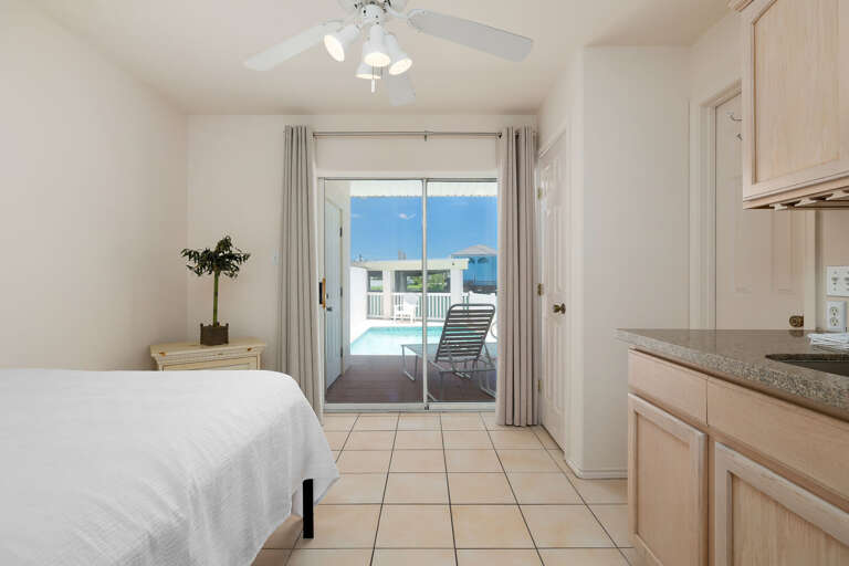 Downstairs bedroom with kitchenette area leads directly to the pool area!