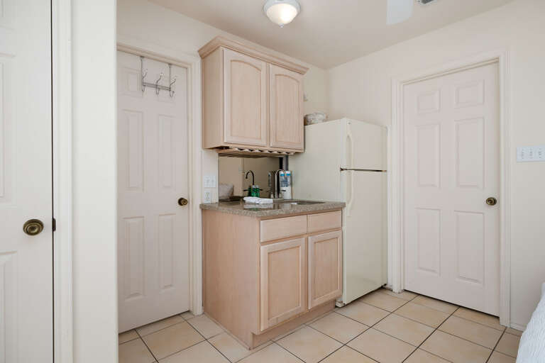 Small Kitchenette area with extra refrigerator located on the ground floor.