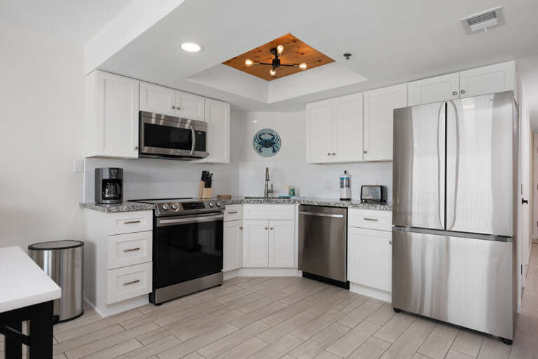 Fully stocked kitchen area with stainless steel appliances