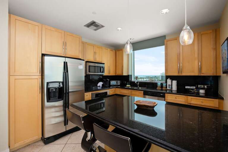 Fully equipped kitchen area stocked with pots, pans, and dish ware to prepare your favorite home cooked meals
