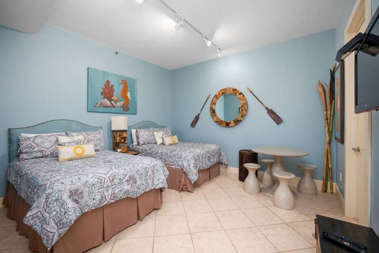 Guests can settle in comfortably in this inviting second bedroom with two full-size beds.