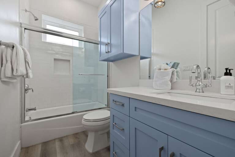 The attached bathroom offers modern finishes and a spacious shower for added comfort and privacy.