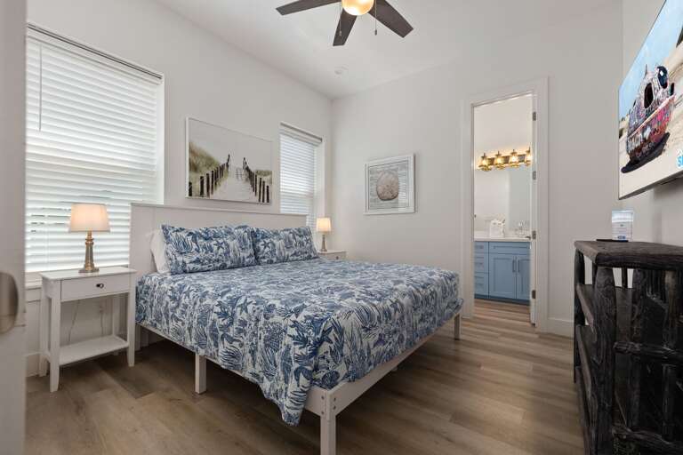 Another comfortable guest bedroom features a king bed, cozy furnishings, and a relaxing atmosphere.