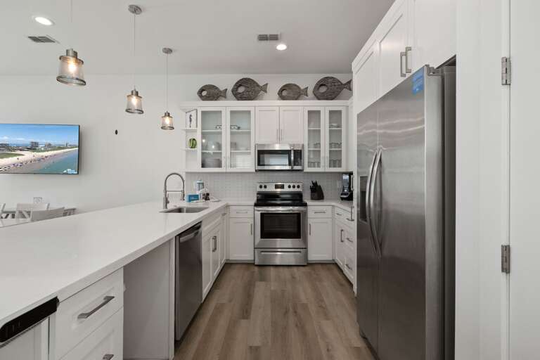 Fully equipped kitchen includes stainless steel appliances and generous counter space.