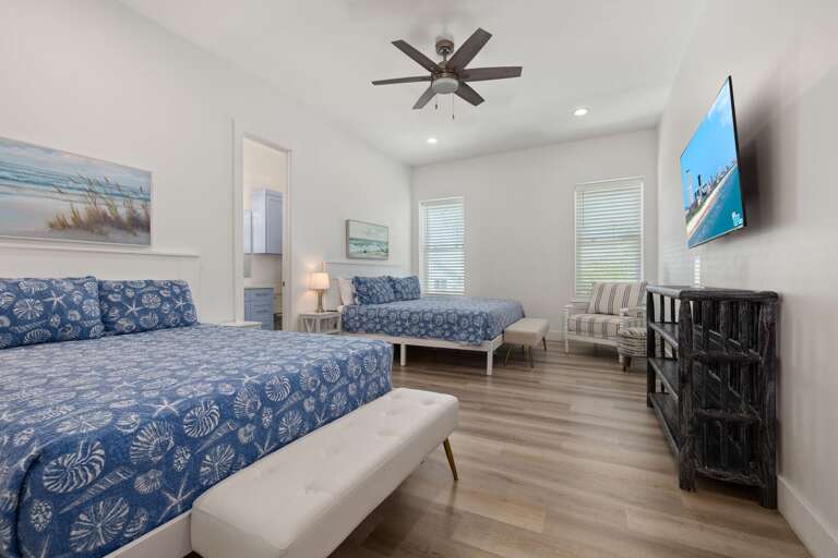 A spacious guest room with one king and one queen bed gives families and friends plenty of flexibility.