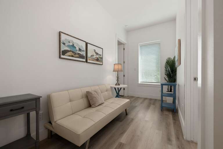 A standard futon provides additional sleeping space for guests, just off the third room.