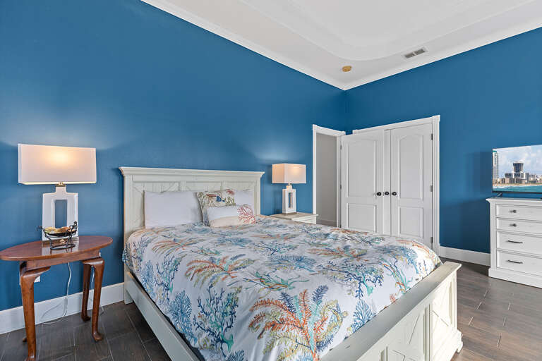 Blue Bedroom With A White Bed And Furniture