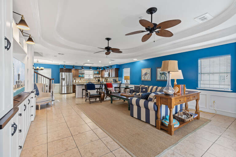 Interior Of A Spacious Living Room With Blue Walls And Ceiling Fans