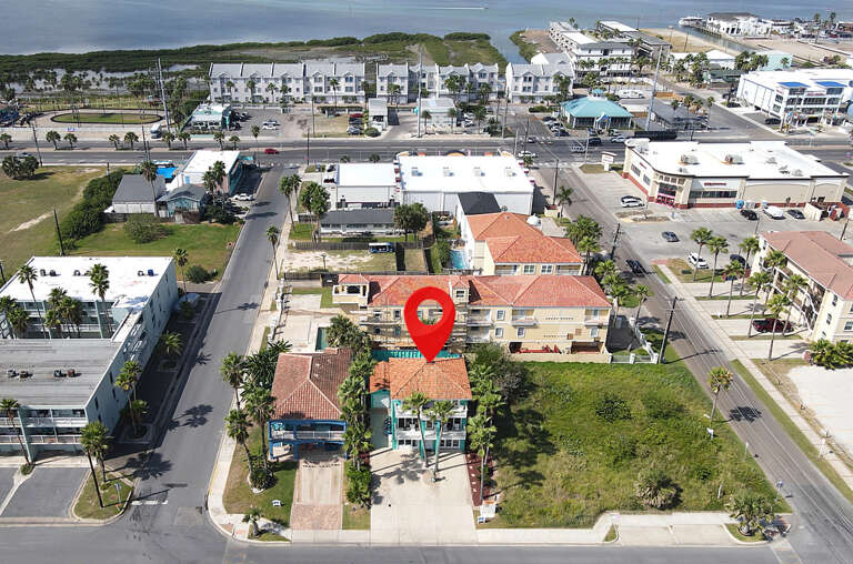 Aerial View Of Coastal Community Complex Near Roads And Vehicles