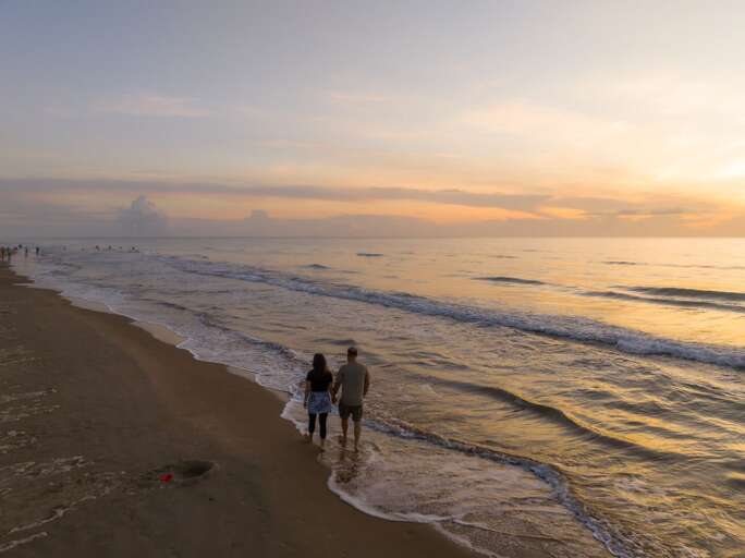 Sunrise Stroll By The Sea, Couple On Sandy Shore