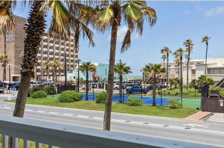Palm Trees And Urban Landscape Viewed From Balcony