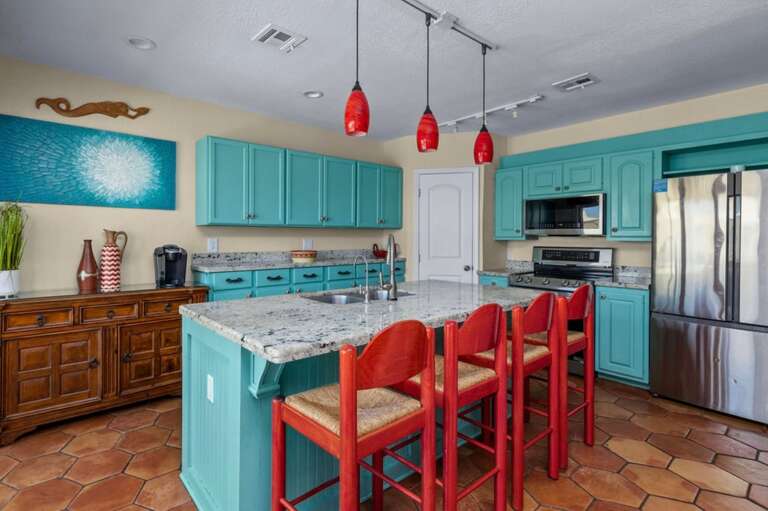 One of three kitchen areas, your main kitchen is fully stocked and has a large center island with state-of-the-art gourmet appliances.