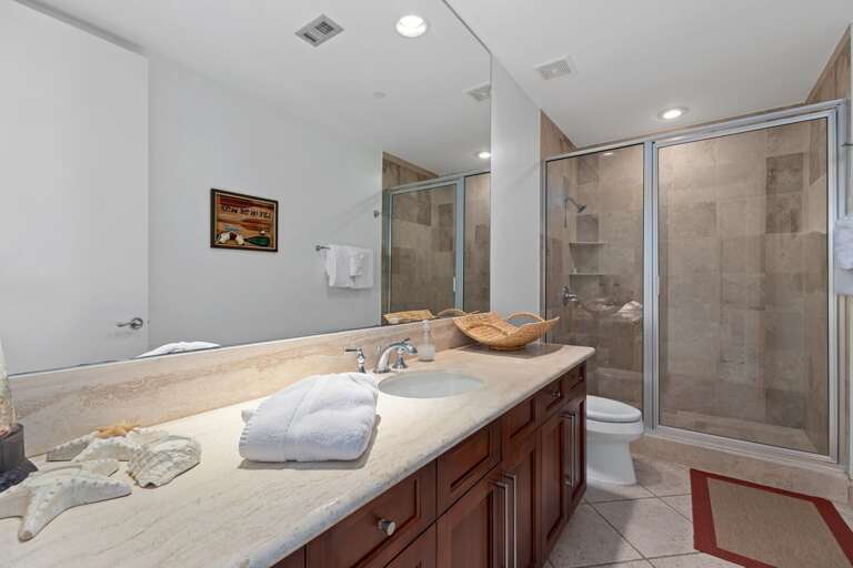 Shared guest bathroom featuring a walk in shower.