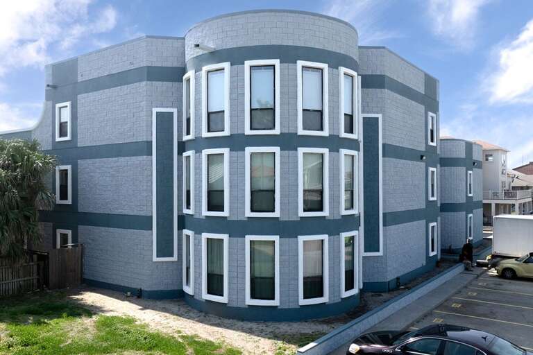 Curved Building With Many Windows Under Blue Sky Curved Building With Many Windows Under Blue Sky