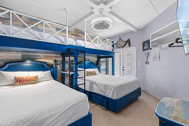 Guest bedroom features twin over queen bunk beds sleeping up to 6 guests comfortably Guest bedroom features twin over queen bunk beds sleeping up to 6 guests comfortably