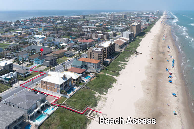 Aerial View Of Bustling Beach Beside Dense Dwellings And Sandy Shores
