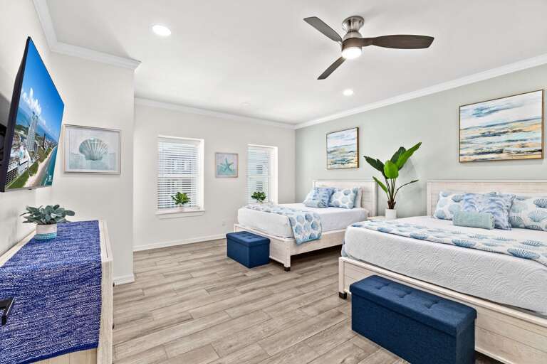 The second bedroom entails two Queen beds, flat screen TV, private bathroom & access to the front balcony.