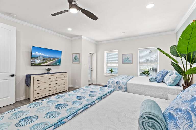 The second bedroom entails two Queen beds, flat screen TV, private bathroom & access to the front balcony.