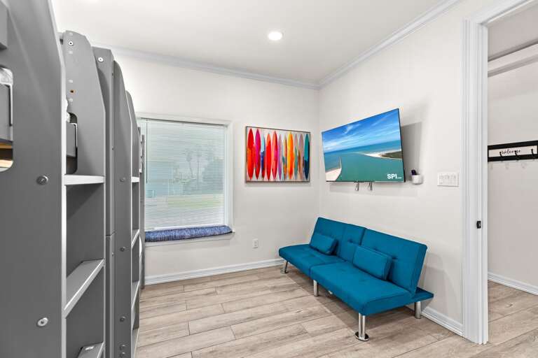 Fifth bedroom is equipped with a large flat screen TV & also has access to a shared guest bathroom.