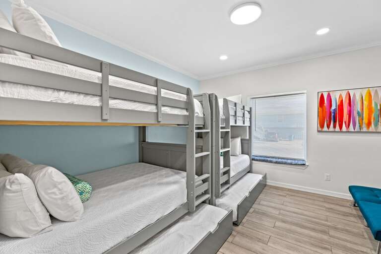 Fifth bedroom located on the ground floor features two full over full bunk beds & two twin trundle beds.