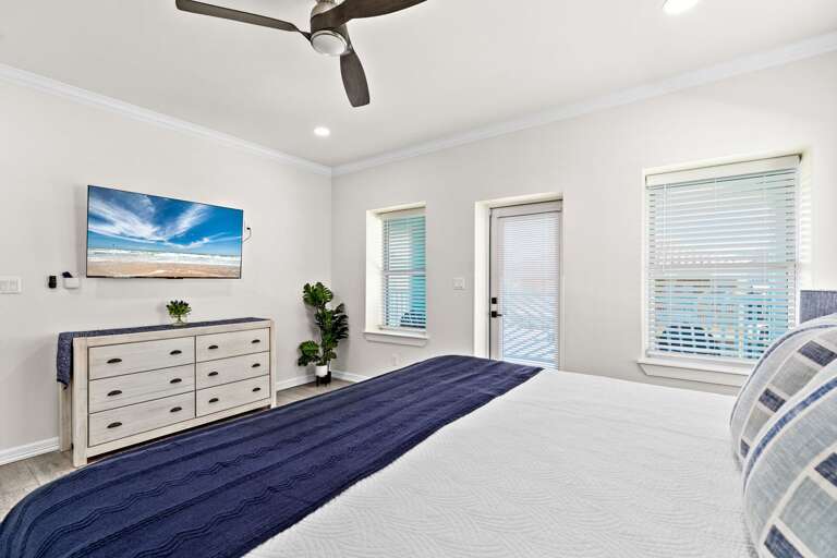 The fourth bedroom entails a King bed, flat screen TV, private bathroom & access to the back balcony overlooking pool.