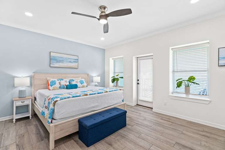 Master bedroom features a King bed, flat screen TV, a private bathroom & access to the front balcony.