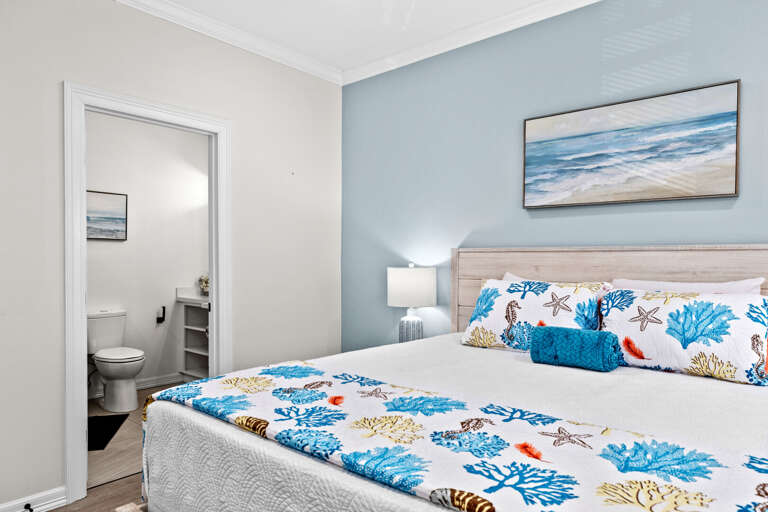 Master bedroom features a King bed, flat screen TV, a private bathroom & access to the front balcony.