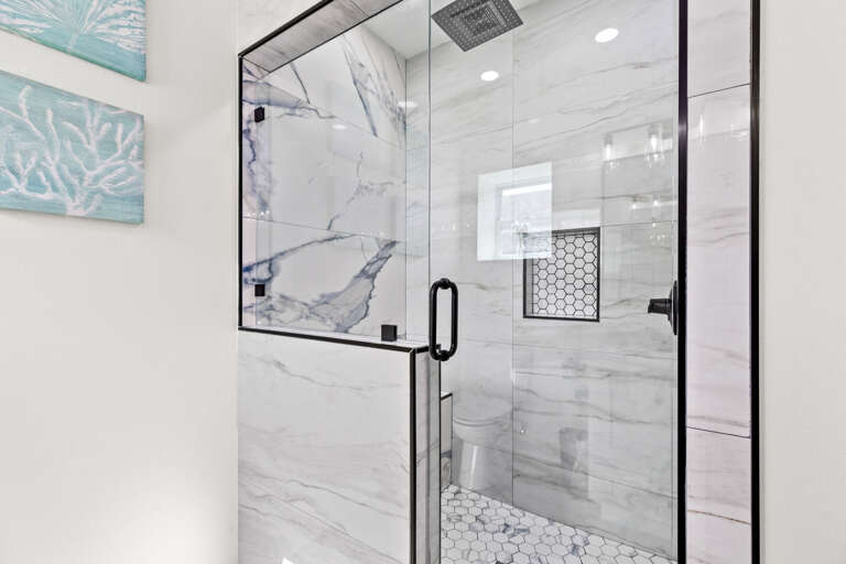 Private bathroom attached to the second bedroom entails double sinks, large vanity mirror & beautiful walk-in shower.