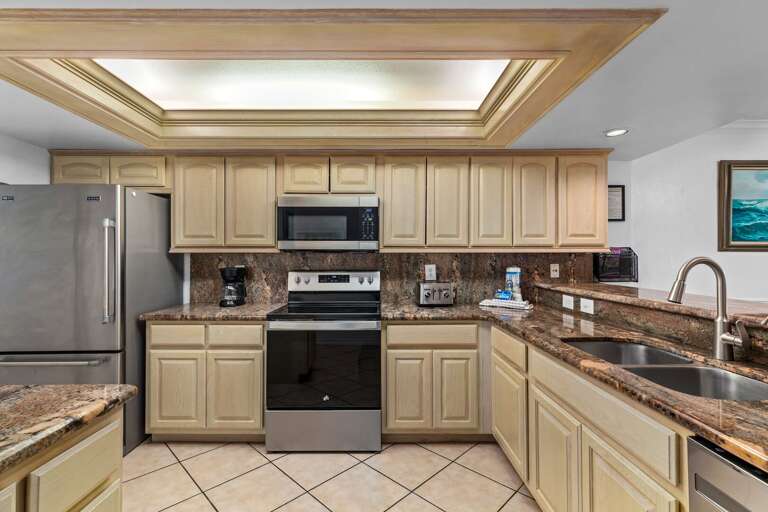 Kitchen stocked with all cookware, dishware, and silverware needed .
