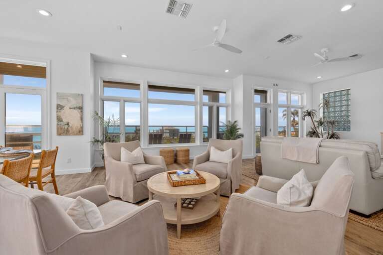 Bright Beachside Living Space With Sea Views Through Wide Windows