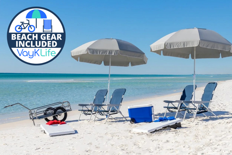 Sunlit Shore With Chairs, Umbrellas, And Beach Gear