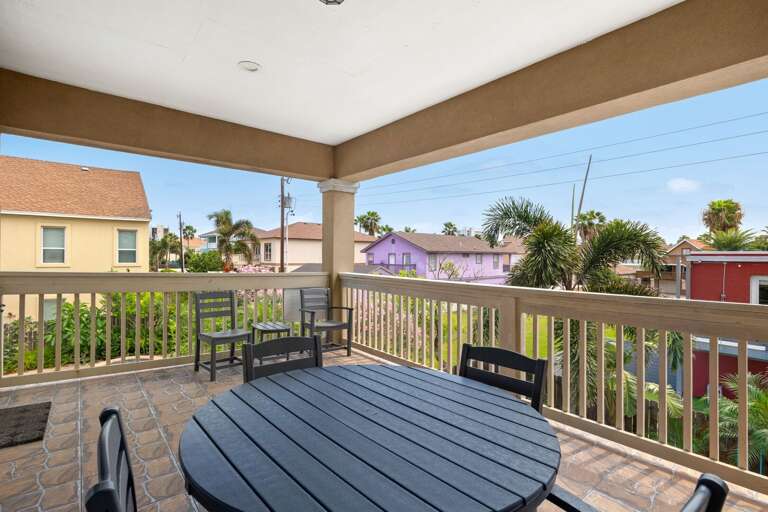 Spacious second-floor balcony featuring an outdoor dining set—ideal for morning coffee or evening meals with a view.