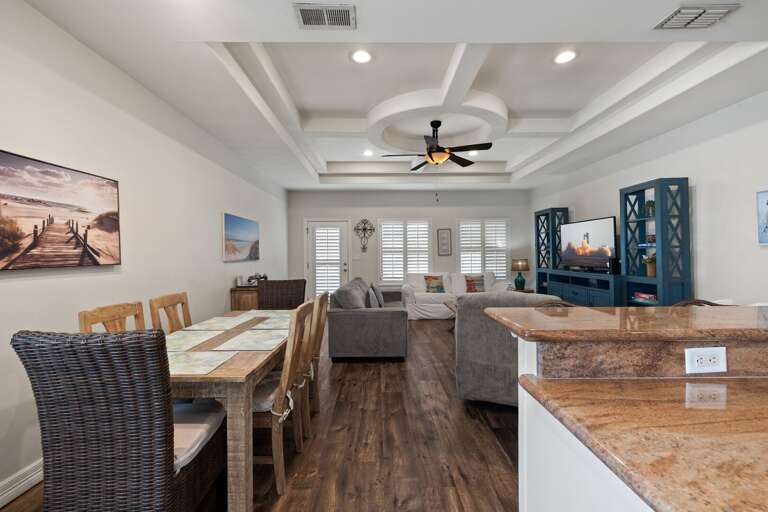 Bright open layout connecting the living room, dining area, and kitchen, ideal for family gatherings and group entertaining.