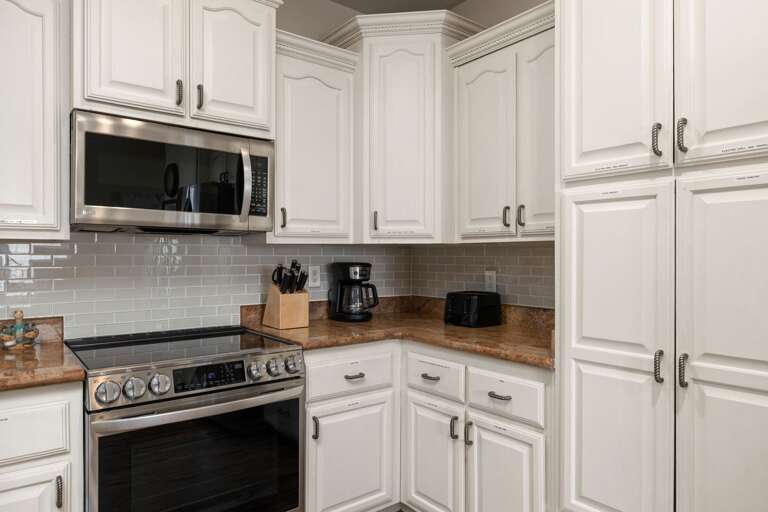 Modern kitchen with stainless steel appliances, ample counter space, and everything you need for preparing meals at home.