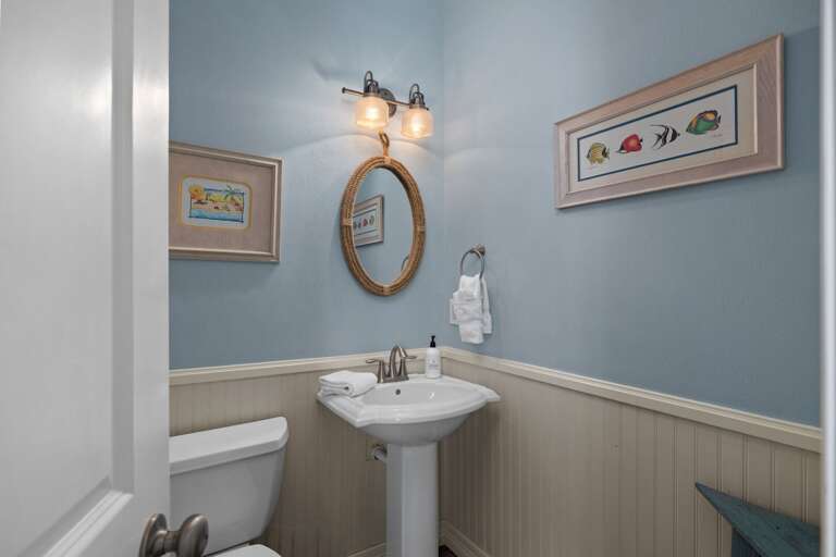 Charming half bathroom with coastal touches and convenient accessibility on the main level.