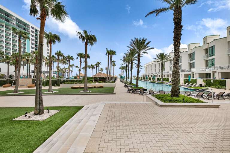 Palm-lined Pathway Leading To Poolside Paradise