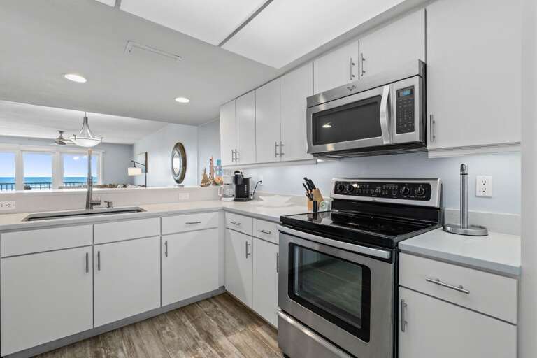 Bright, modern kitchen with stainless steel appliances and sleek finishes for easy vacation cooking.