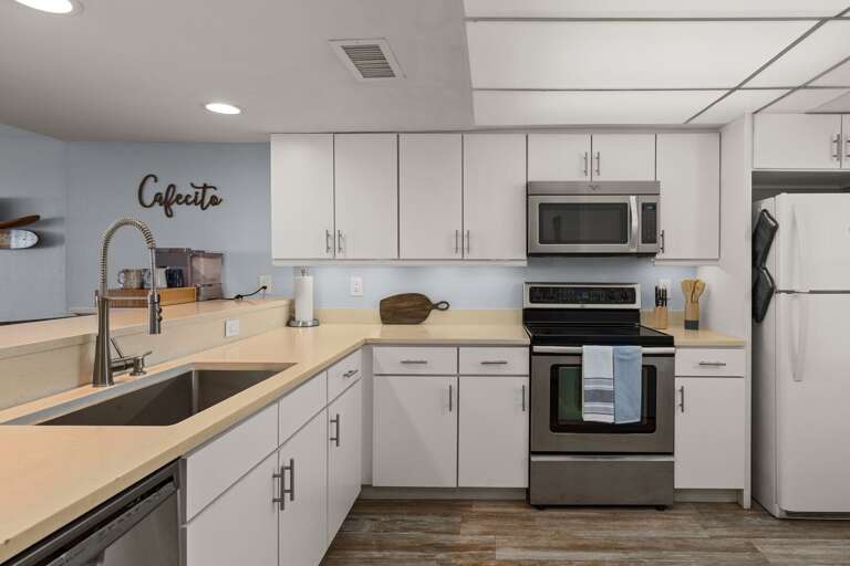Bright, modern kitchen with stainless steel appliances and sleek finishes for easy vacation cooking.