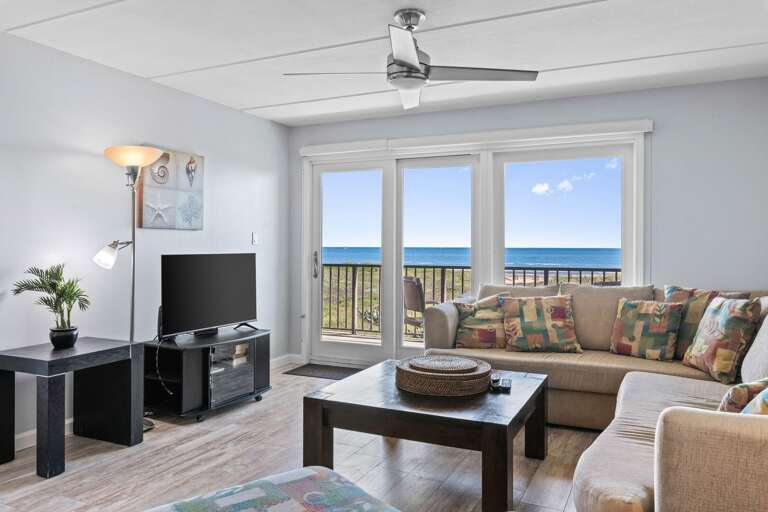 Comfortable seating area showcasing stunning Gulf views—perfect for morning coffee or sunset watching.