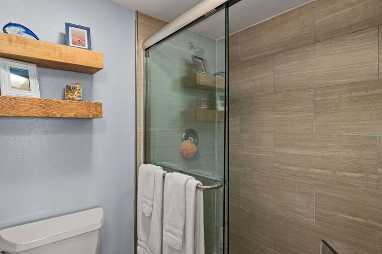 Master Bathroom - Bright and modern bathroom featuring a glass-enclosed shower, sleek tile design, and fresh towels.